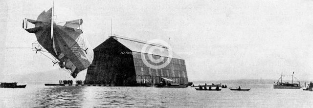 A Zeppelin entering its floating shed, c 1900, (c1920). Artist: Unknown