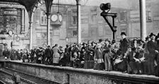 A bank holiday crowd waiting for a train to Margate, London, 1926-1927
