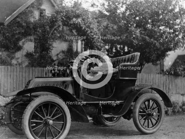 A baby on the seat of a De Dion Bouton car, 1903. Artist: Unknown