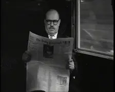 A Bald Man Wearing Spectacles Reading The Daily Telegraph in the Carriage of a Train..., 1938. Creator: British Pathe Ltd
