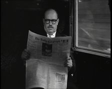 A Bald Man Wearing Spectacles Reading The Daily Telegraph in the Carriage of a Train..., 1938. Creator: British Pathe Ltd