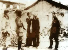 A barber watched by German troops, World War II, c1939-c1945. Creator: Unknown