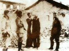 A barber watched by German troops, World War II, c1939-c1945. Creator: Unknown