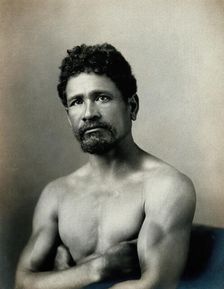 A barechested, bearded Samoan man, with his arms crossed, c1900. Creator: Unknown