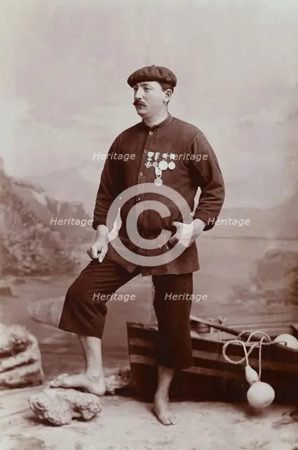 A barefoot Basque fisherman posing with several medals on his tunic, undated, estimated c1900s. Creator: Unknown.