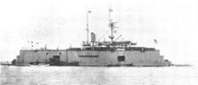 A battle-ship docked on the water: H.M.S. "Sans Pareil" on a floating-dock in the Tyne, 1909. Creator: L.N.A.