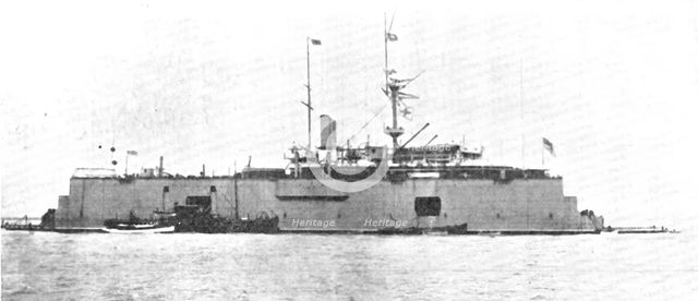 A battle-ship docked on the water: H.M.S. "Sans Pareil" on a floating-dock in the Tyne, 1909. Creator: L.N.A..