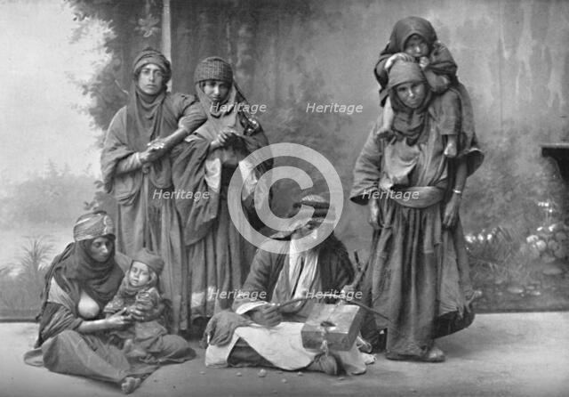 A Bedouin musician and his audience, 1902. Artist: Unknown.