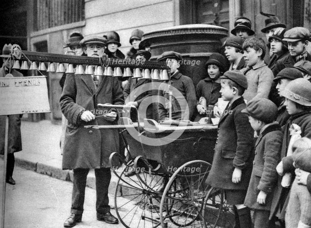 A bell busker, London, 1926-1927.Artist: McLeish