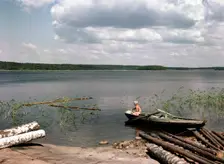 A boy fishing from a rowing boat during his summer holidays, Sweden, 1950s. Creator: Göran Algård