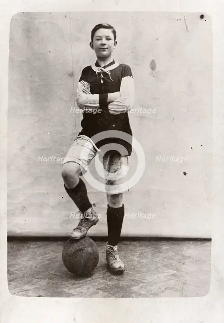 A boy poses in football kit, 1910. Artist: Unknown