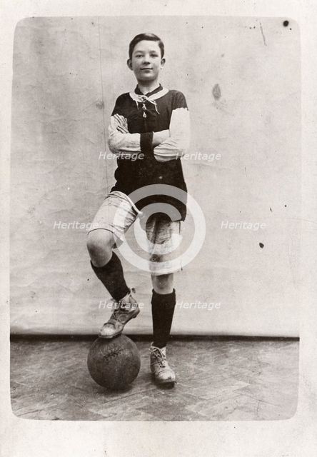 A boy poses in football kit, 1910. Artist: Unknown
