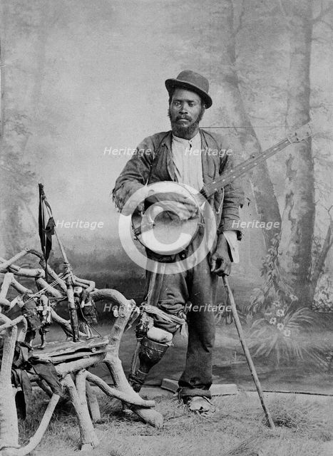 A black banjo player with a wooden leg, c1865. Creator: Unknown.