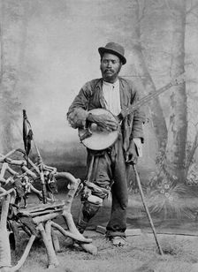 A black banjo player with a wooden leg, c1865. Creator: Unknown