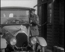 A British Automobile Association Employee Filling a Car With Petrol at the First Petrol Station,1920 Creator: British Pathe Ltd