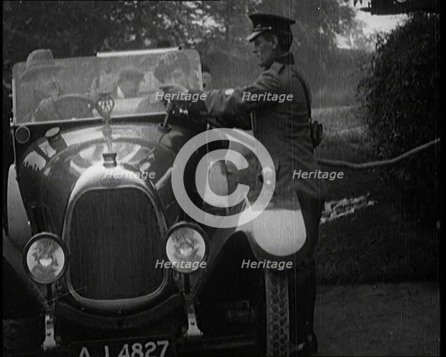 A British Automobile Association Employee Filling a Car With Petrol at a Petrol Station, 1920. Creator: British Pathe Ltd.