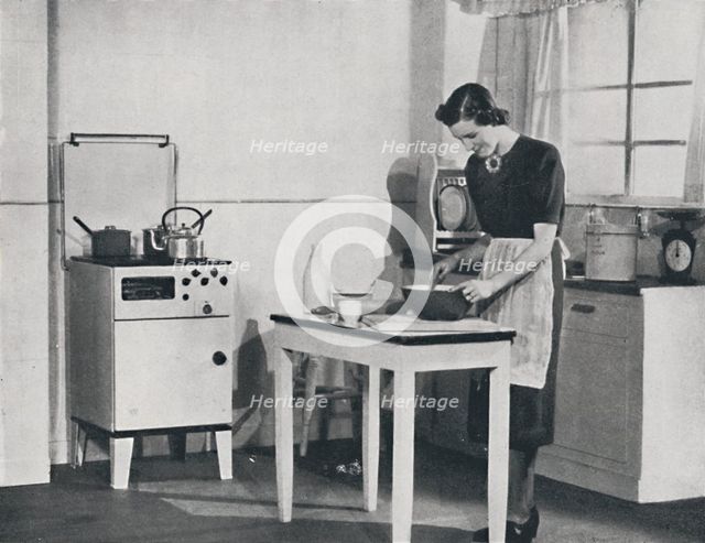 'A British kitchen equipped with a cabinet gas cooker', 1942.  Artist: Unknown.