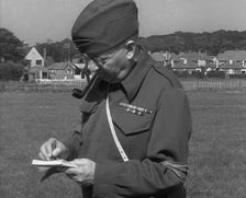 A British Local Defence Volunteer Writing Notes, 1940. Creator: British Pathe Ltd
