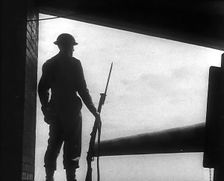A British Soldier Guarding a Gun Emplacement, 1940. Creator: British Pathe Ltd