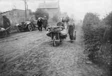A British soldier helping a woman return to her village, France, 1918