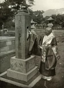 A Buddhist Priest and Praying-Wheel 1910. Creator: Herbert Ponting