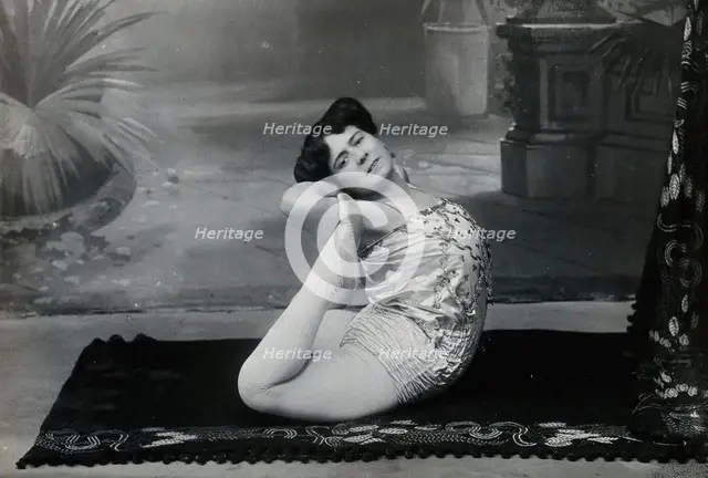 A Bulgarian female acrobat performing contortions in a photographic studio, between 1890 and 1910. Creator: Unknown.