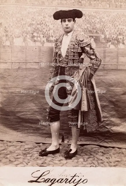 A bullfighter, Rafael Molina Sanchez "Lagartijo", posing in front of a painted back..., c1870s. Creator: Unknown.