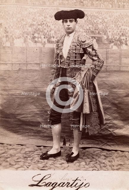 A bullfighter, Rafael Molina Sanchez "Lagartijo", posing in front of a painted back..., c1870s. Creator: Unknown.