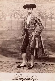 A bullfighter, Rafael Molina Sanchez "Lagartijo", posing in front of a painted back..., c1870s. Creator: Unknown