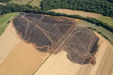 A burnt out combine harvester and fire scorched fields near Pleasley, Derbyshire, 2022. Creator: Emma Trevarthen