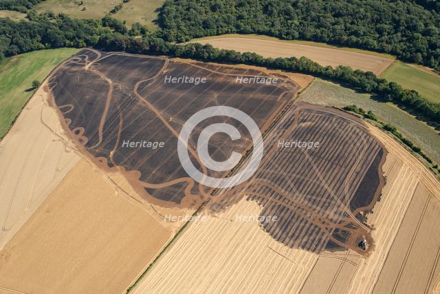A burnt out combine harvester and fire scorched fields near Pleasley, Derbyshire, 2022. Creator: Emma Trevarthen.