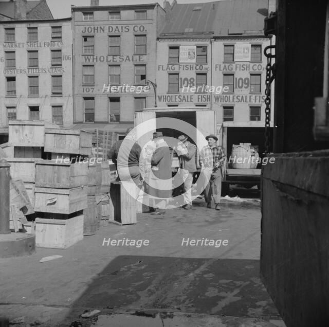 A buyer visits the wholesale district to purchase fish for his store, New York, 1943. Creator: Gordon Parks.