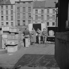 A buyer visits the wholesale district to purchase fish for his store, New York, 1943. Creator: Gordon Parks