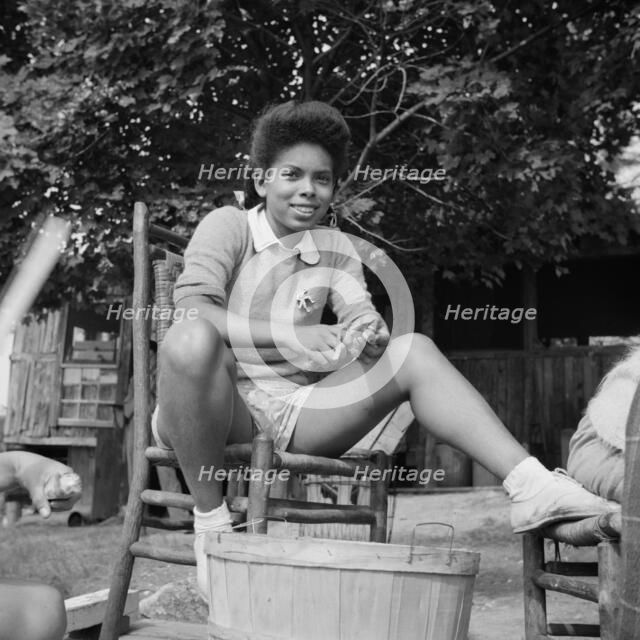 A camper helping with the kitchen work at Camp Gaylord White, Arden, New York, 1943. Creator: Gordon Parks.