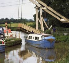 A canal boat passing under a lift bridge on the Llangollen Canal, 1970. Artist: Michael Walters