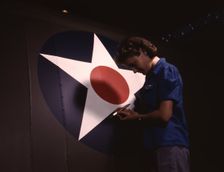 A candid view of one of the women workers touching up...Vultee's Nashville division, Tennessee, 1943 Creator: Alfred T Palmer