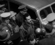 A Captured Italian Pilot Being Escorted Through a Train Station, 1940. Creator: British Pathe Ltd