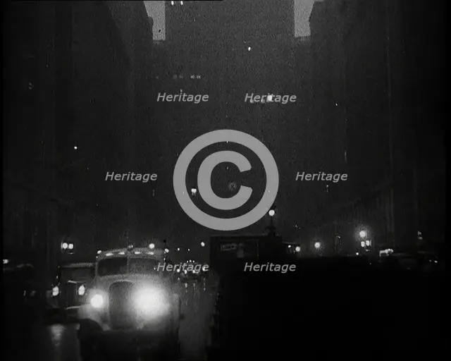 A Car Driving Towards the Camera With Very Bright Head Lights On the Streets of New York..., 1932. Creator: British Pathe Ltd.