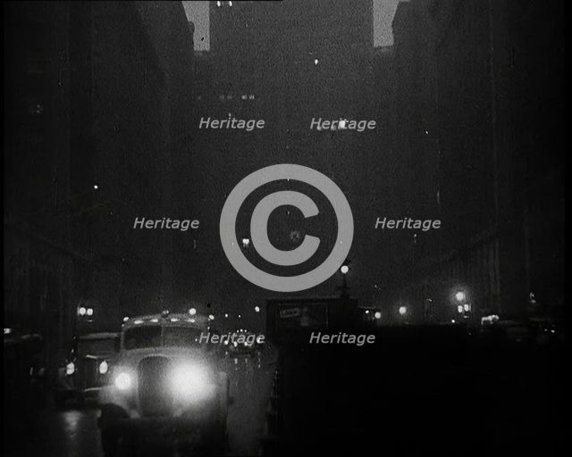 A Car Driving Towards the Camera With Very Bright Head Lights On the Streets of New York..., 1932. Creator: British Pathe Ltd.