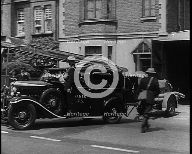 A Car With a Fire Hose attached Driving Away, 1940. Creator: British Pathe Ltd.