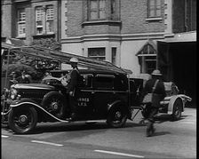 A Car With a Fire Hose attached Driving Away, 1940. Creator: British Pathe Ltd