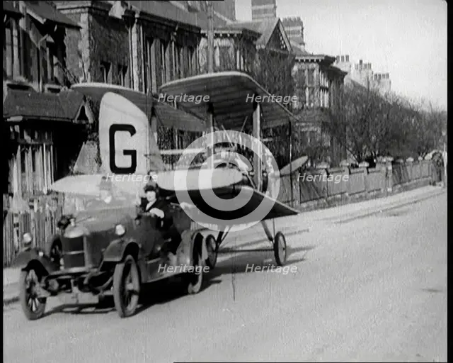 A Car Towing a Small Aeroplane With Its Wings Folded Over Along the Road, 1924. Creator: British Pathe Ltd.