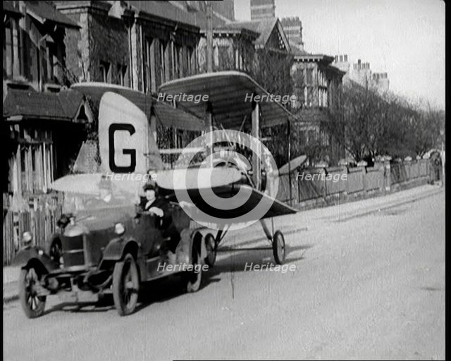 A Car Towing a Small Aeroplane With Its Wings Folded Over Along the Road, 1924. Creator: British Pathe Ltd.