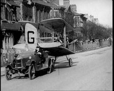 A Car Towing a Small Aeroplane With Its Wings Folded Over Along the Road, 1924. Creator: British Pathe Ltd