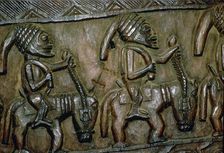 A carved wooden door from Nigeria depicting men on horseback
