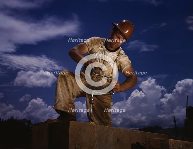 A carpenter at the TVA's new Douglas dam on the French Broad River, Tenn., 1942. Creator: Alfred T Palmer.