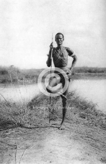 A characteristic Dinka attitude, Terrakekka to Aweil, Sudan, 1925 (1927). Artist: Thomas A Glover