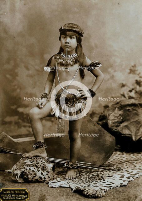 A child of an Amazonian Indian tribe, standing on a leopard skin, in a photographic studio, 1900. Creator: Unknown.