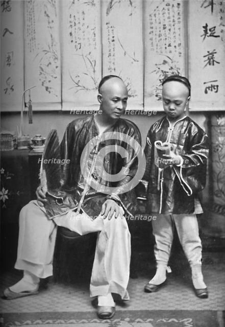 A Chinese schoolmaster and pupil, 1902. Artist: CC Pierce & Co.