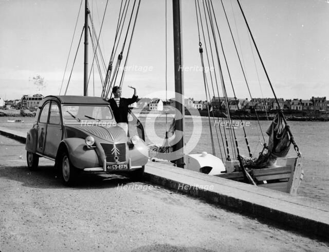 A Citroën 2CV on the quay at a harbour, c1957. Artist: Unknown